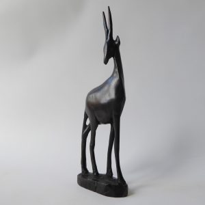 Black wood African gazelle antelope. Modernist sculpture, hand carved figurine