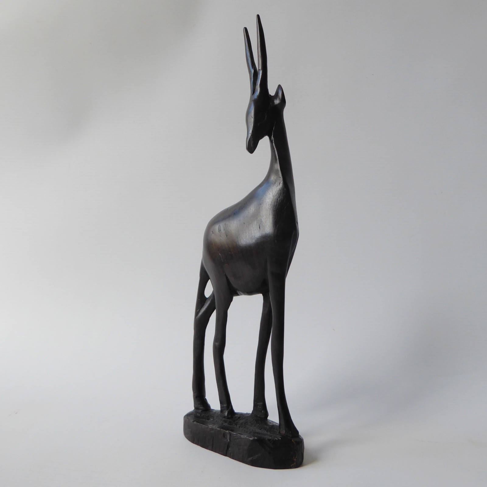 Black wood African gazelle antelope. Modernist sculpture, hand carved figurine