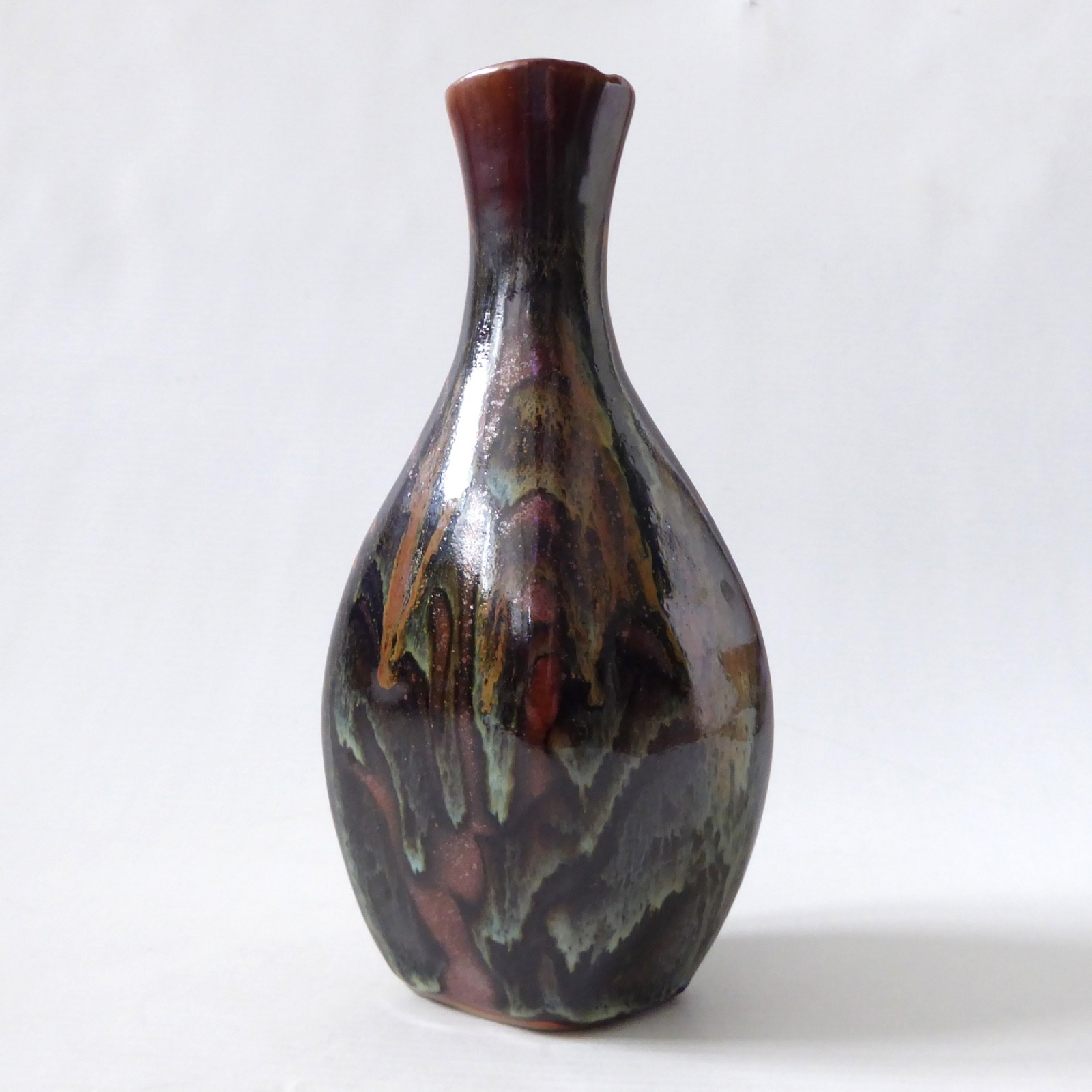 Glazed vintage art pottery vase, studio. Black brown green drip, flat oval vase