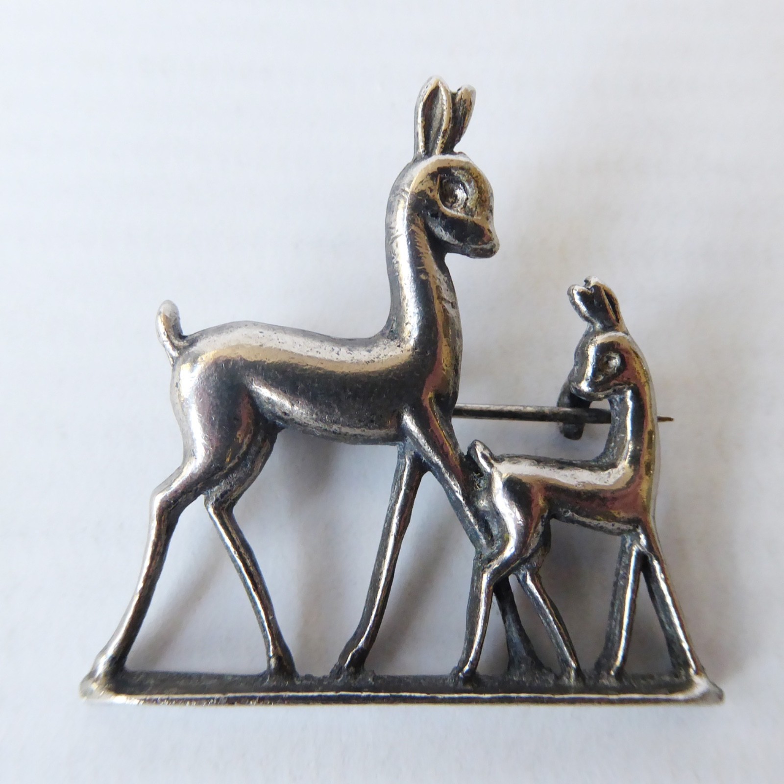 Scandinavian vintage deer silver-tone white cast metal brooch. Doe & fawn deers